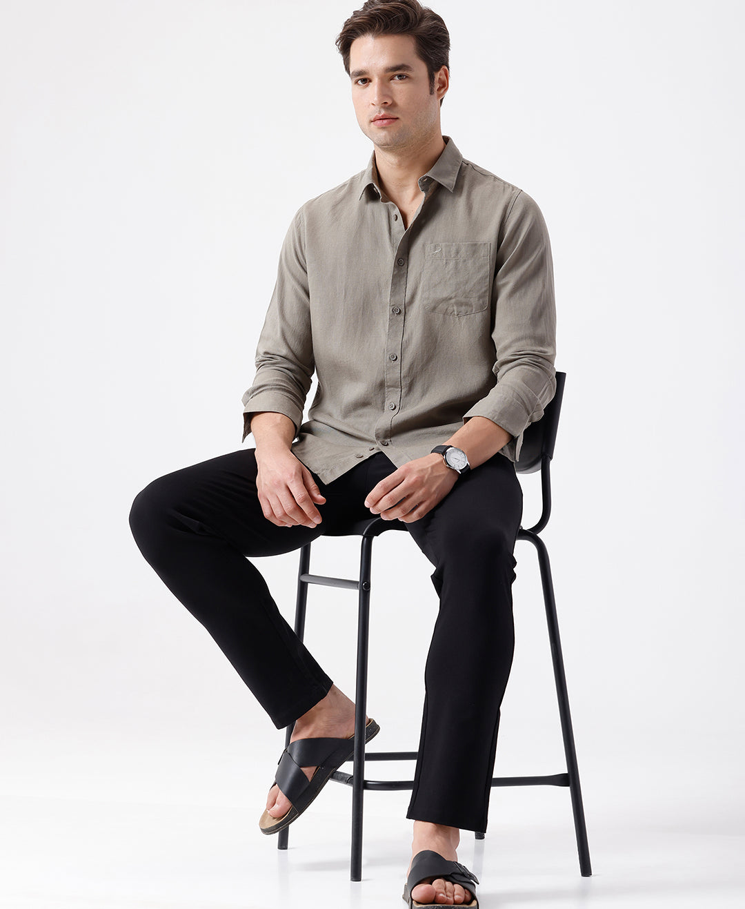 Man wearing a beige linen blend shirt in dark beige on a light gray background