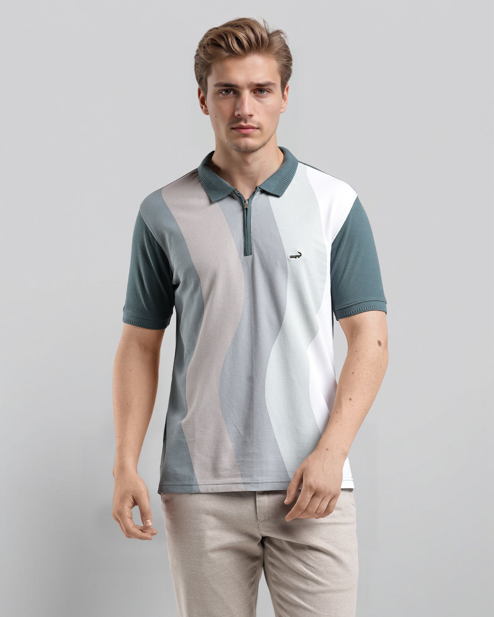 Man wearing a color-blocked polo shirt and beige pants on a gray background