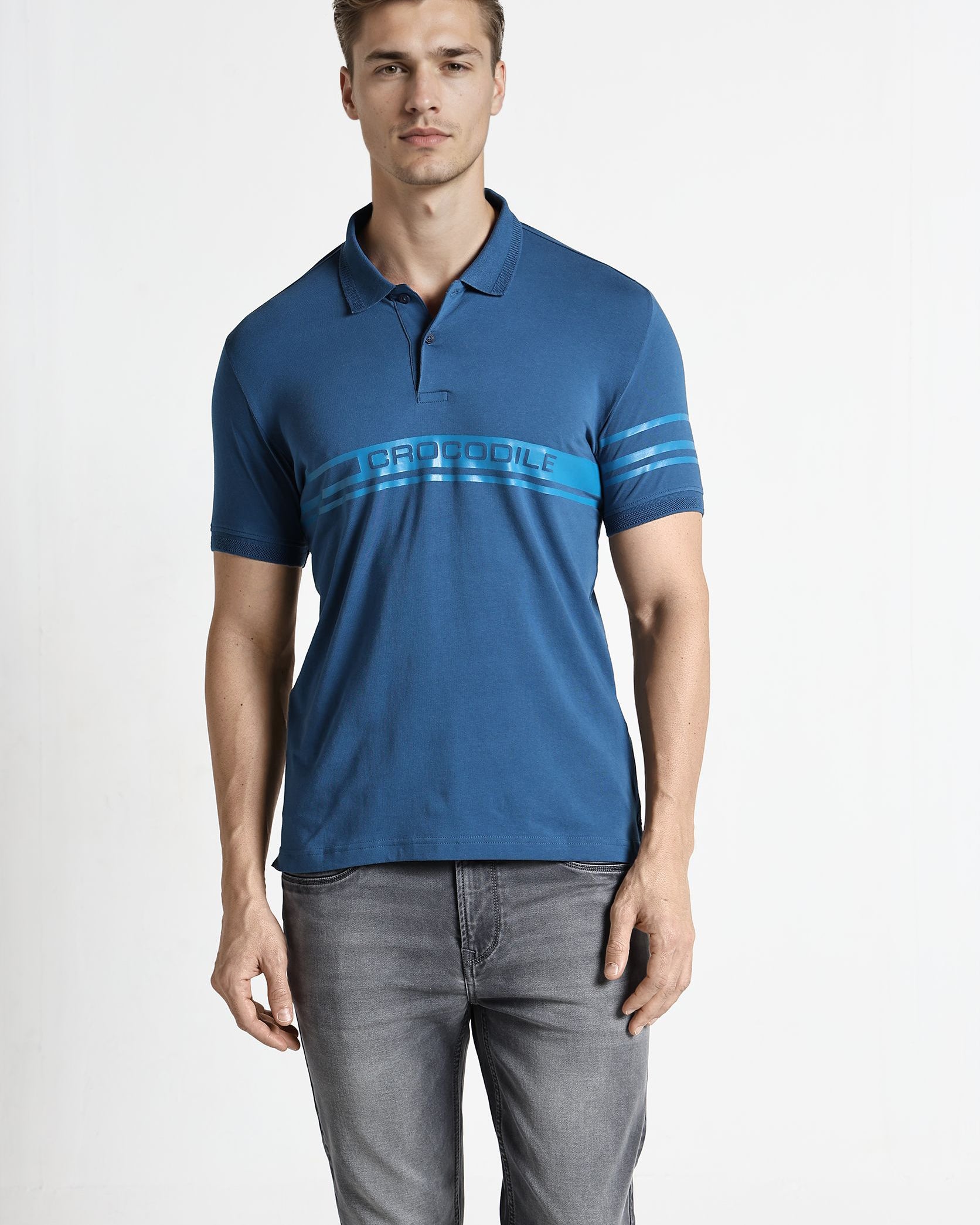 Man wearing a blue polo shirt with a brand logo on a white background