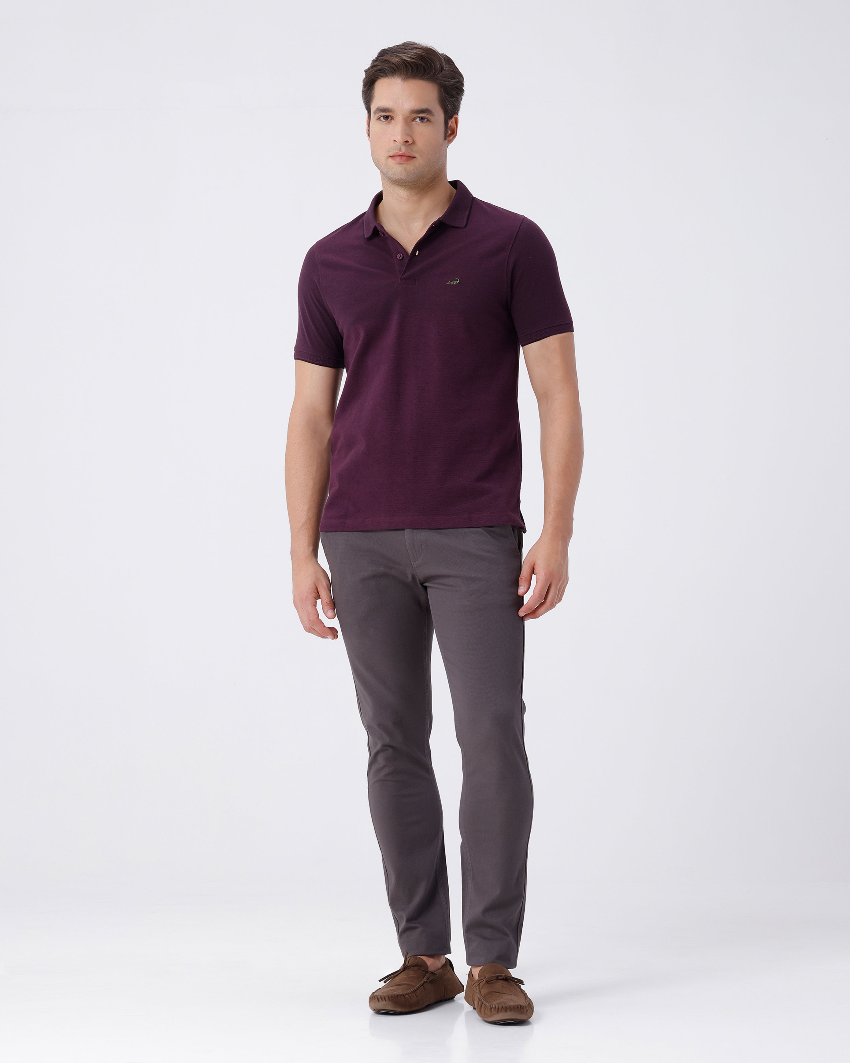 Woman wearing a grey textured essential chinos in dark grey with casual styling on a gray background