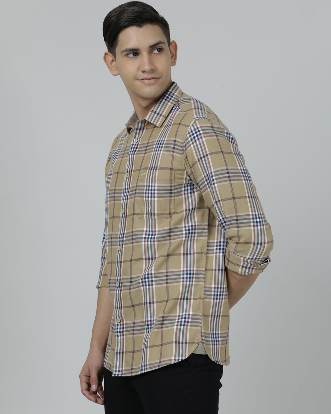 Man wearing a brown khaki brown checked full sleeve 100% cotton shirt with casual styling on a gray background