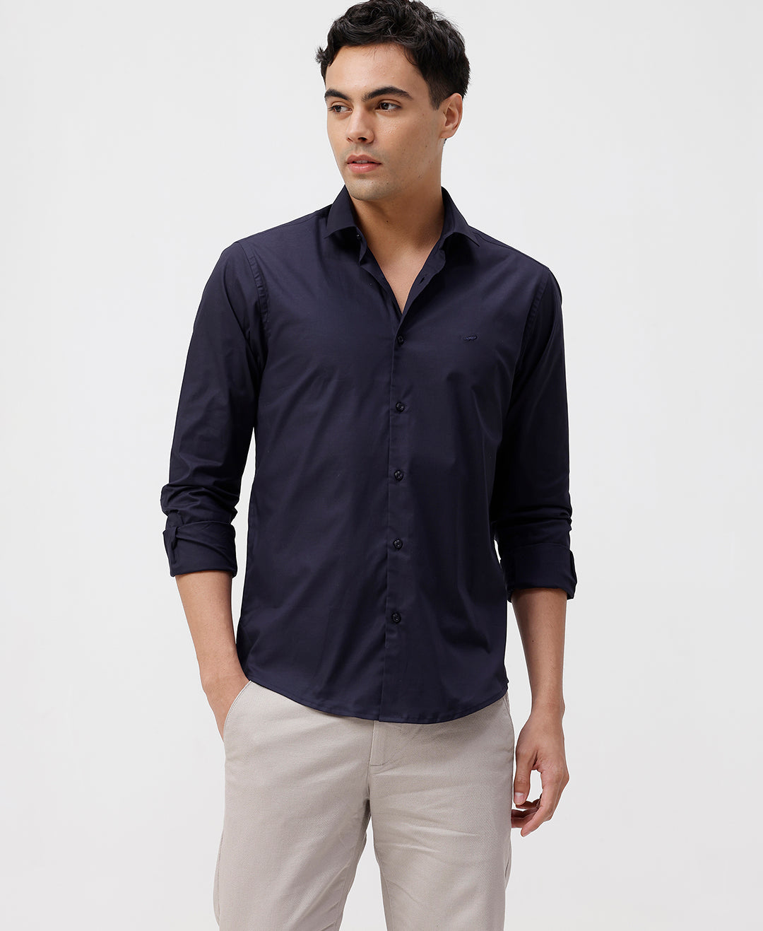 Man wearing a navy mercerized stretch shirt navy with casual styling on a gray background