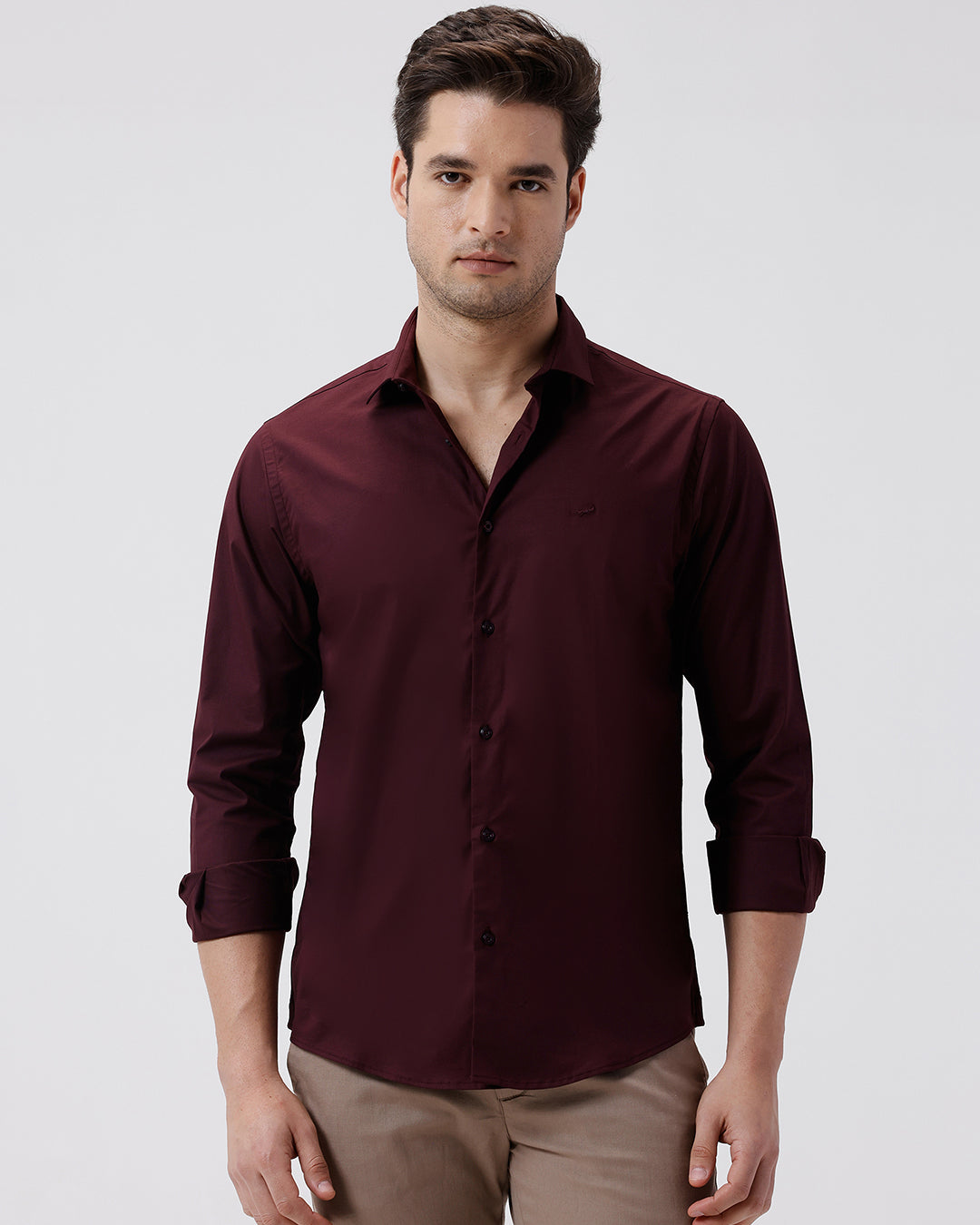 Man wearing a mercerized stretch shirt maroon with casual styling on a gray background