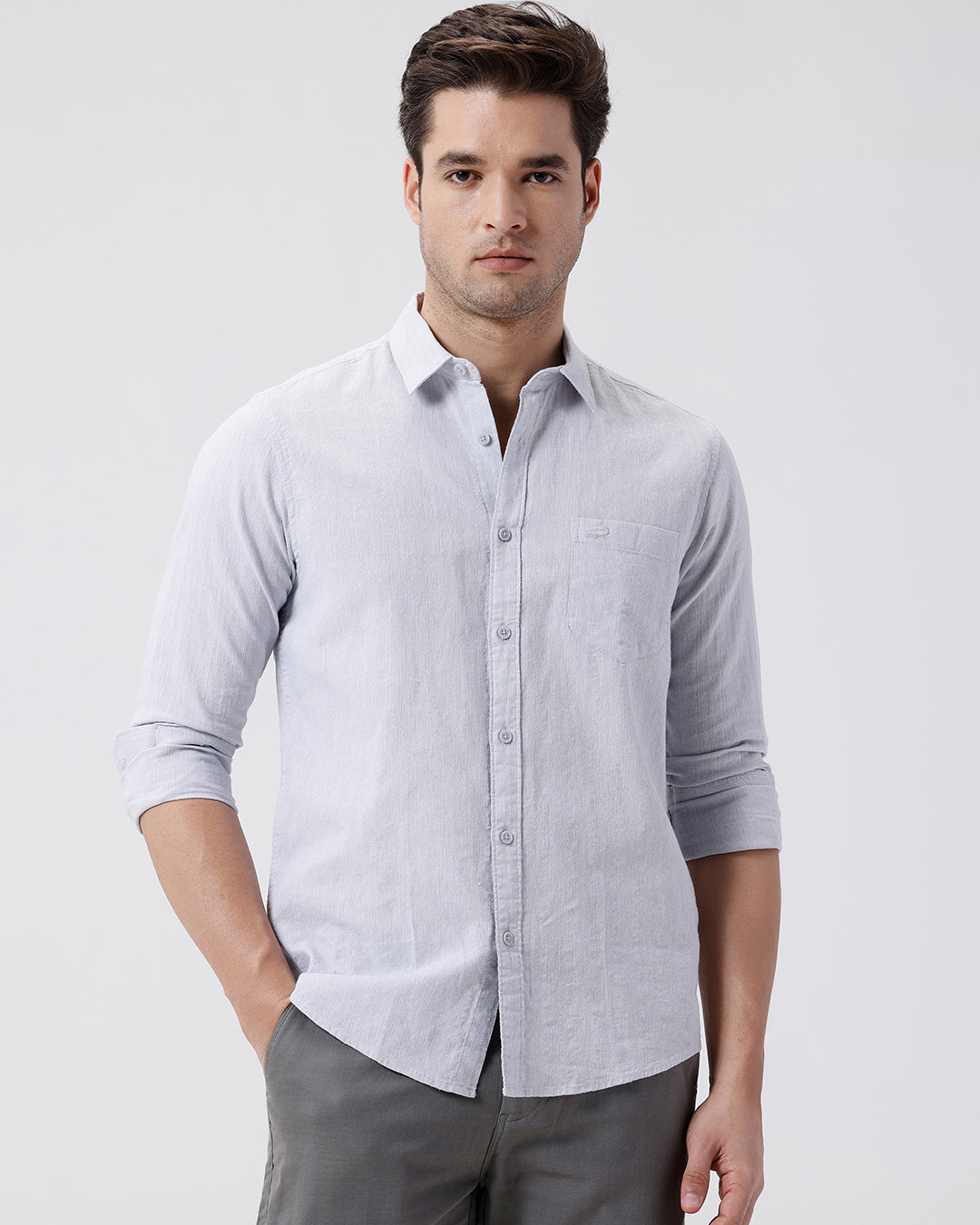 Man wearing a grey rib textured cotton shirt grey on a light gray background