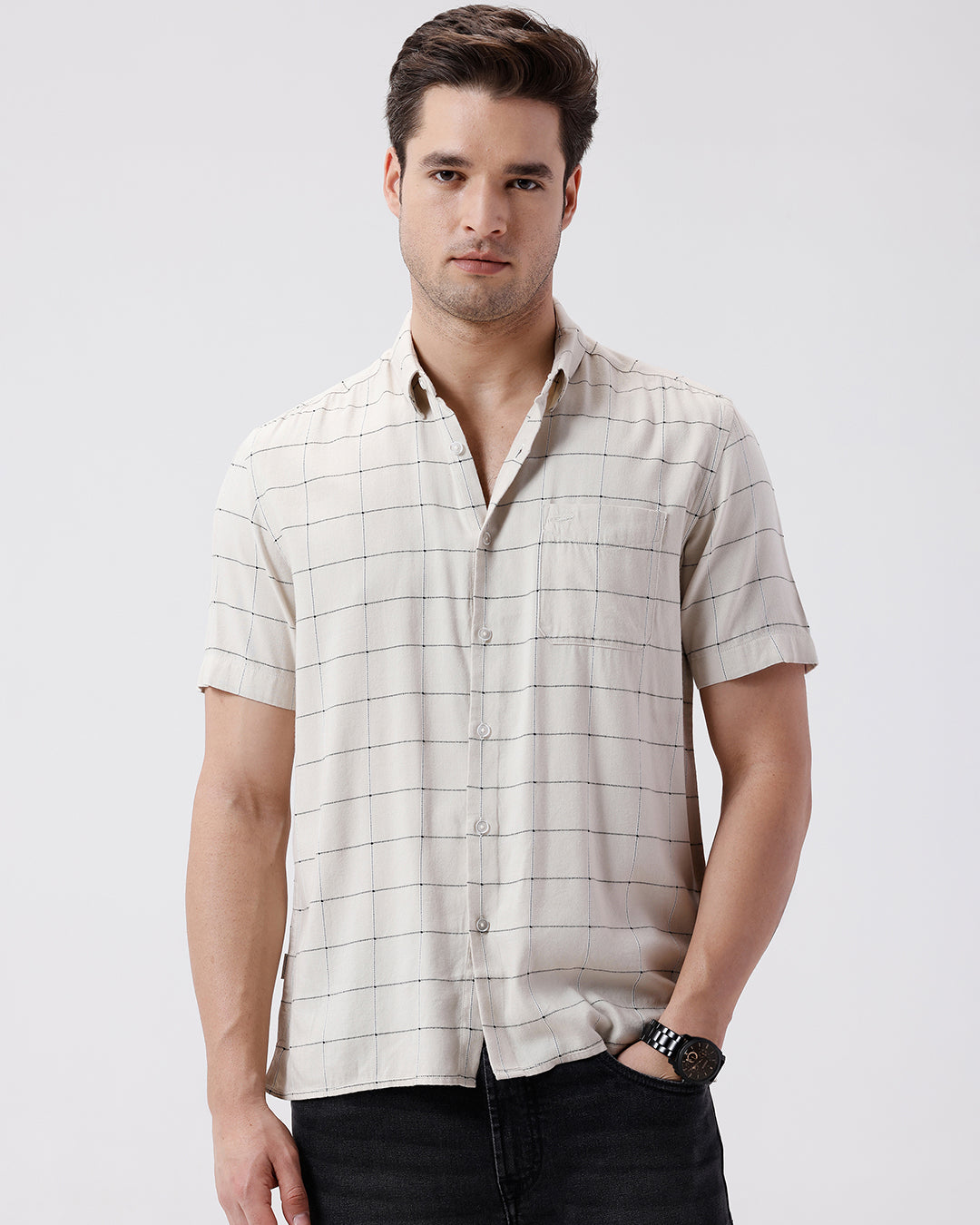 Man wearing a relax fit window pane checks shirt on a light gray background