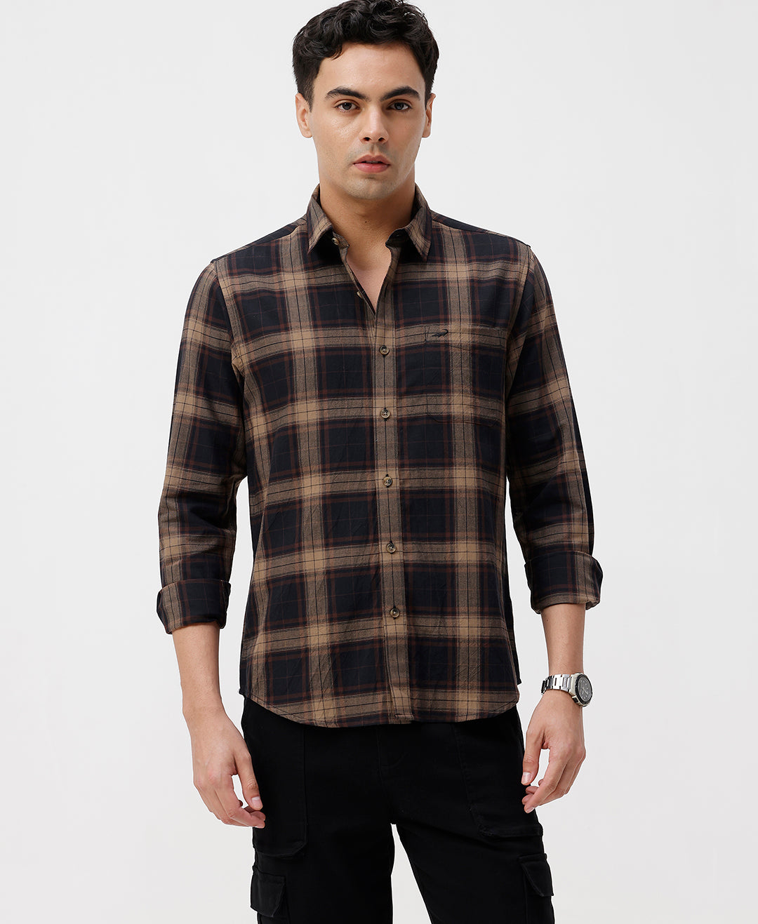 Man wearing a brown oxford checks shirt brown with casual styling on a gray background
