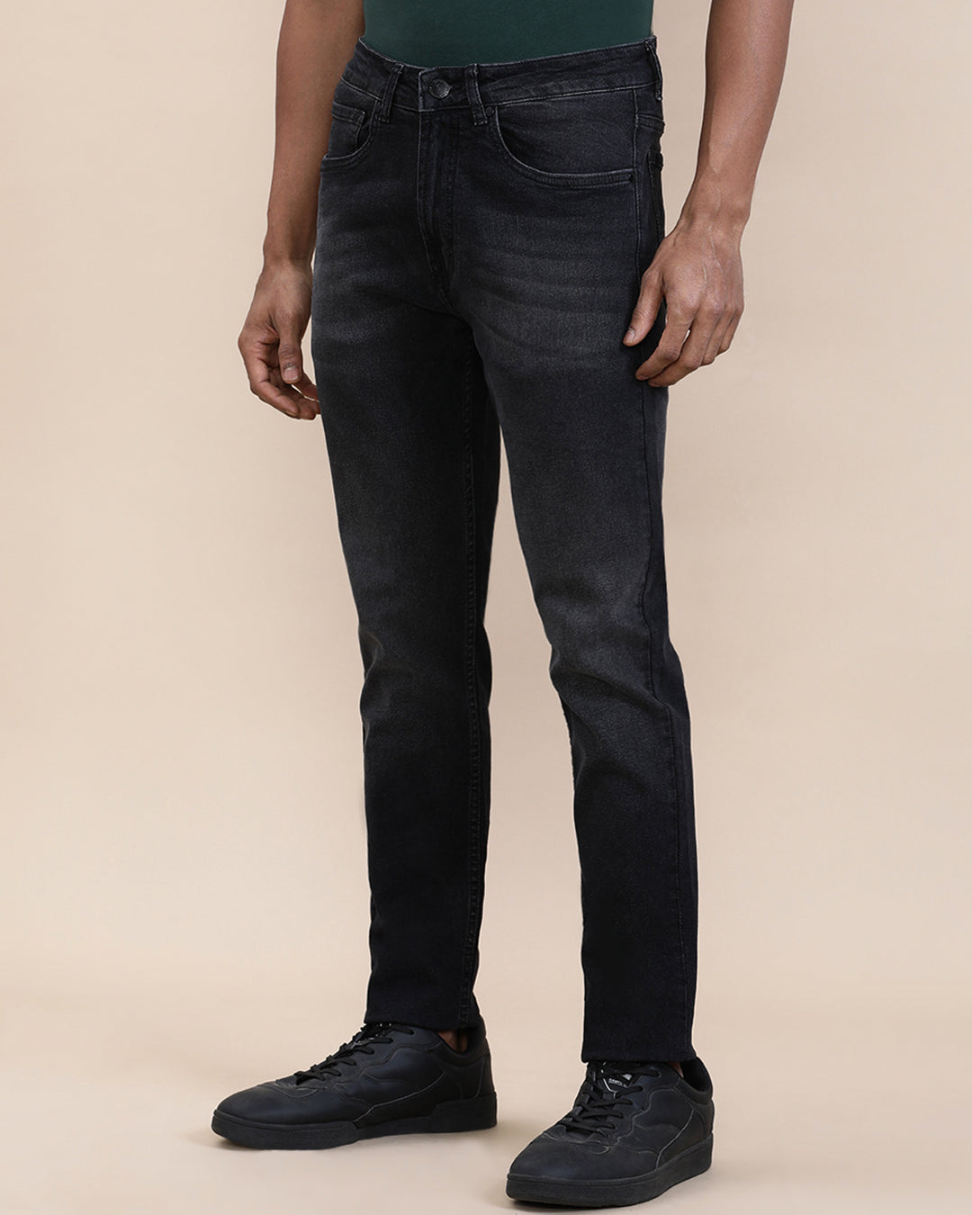 Man wearing a red natural fade wash slim tapered jeans on a light gray background