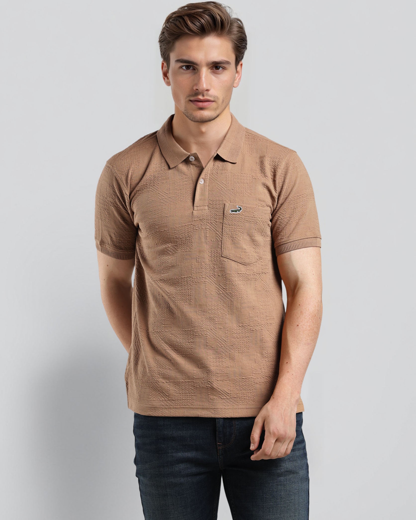 Man wearing a brown polo shirt with a small logo on a light gray background