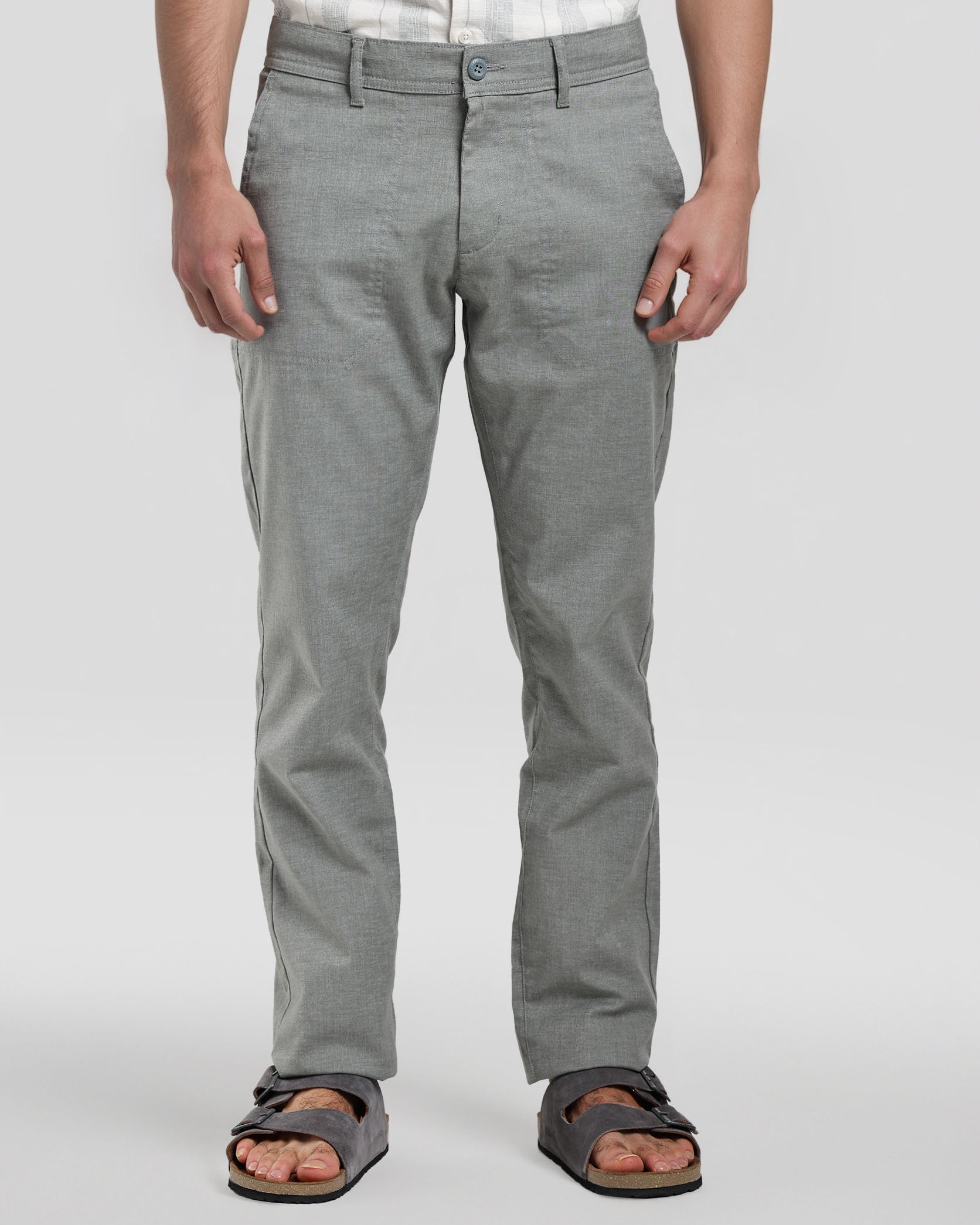 Person wearing gray pants on a white background