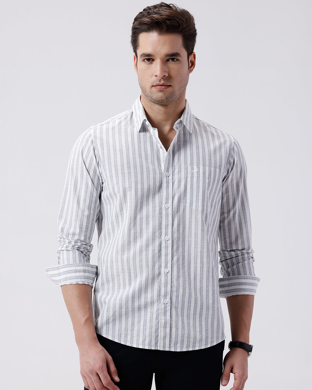 Man wearing a blue stripe textured pure cotton shirt blue on a light gray background