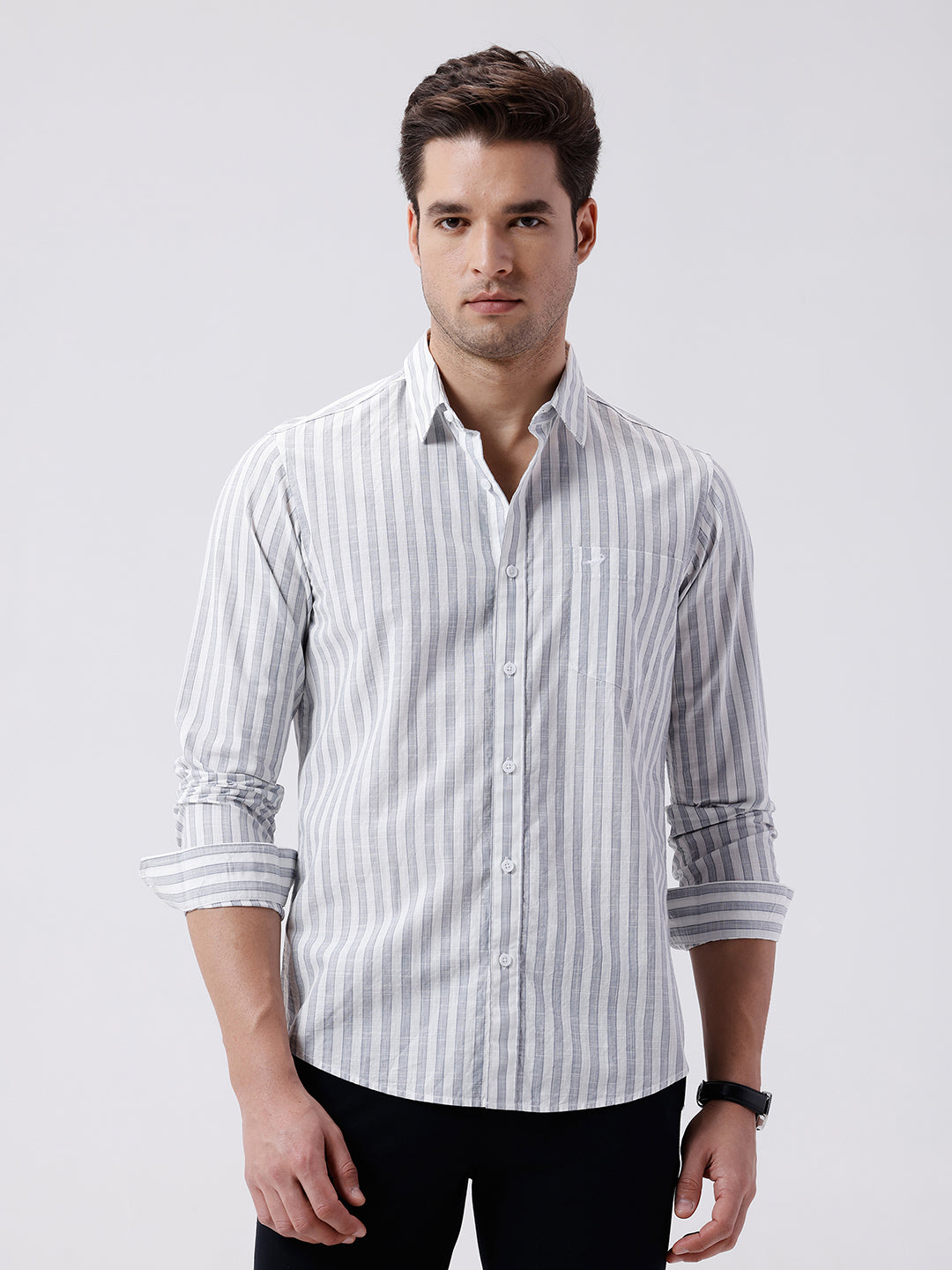 Man wearing a blue stripe textured pure cotton shirt blue on a light gray background