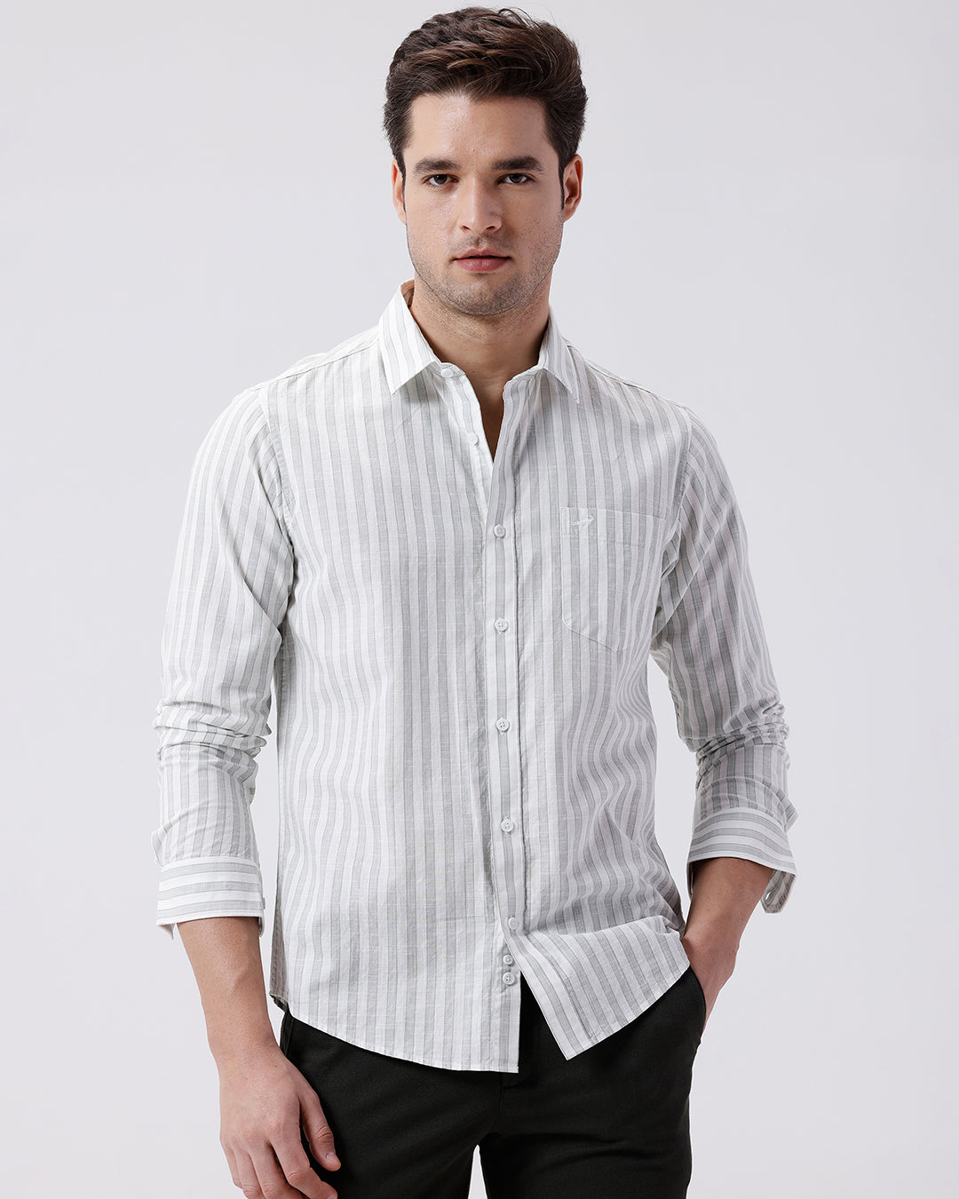 Man wearing a green stripe textured pure cotton shirt green on a light gray background