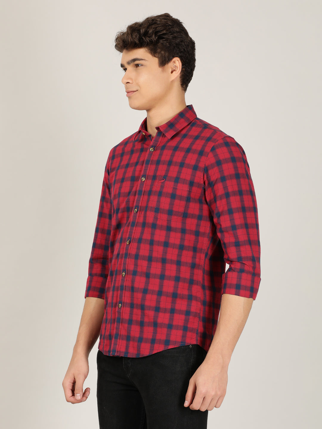 Man wearing a red red checked full sleeve 100% cotton casual shirt on a light gray background