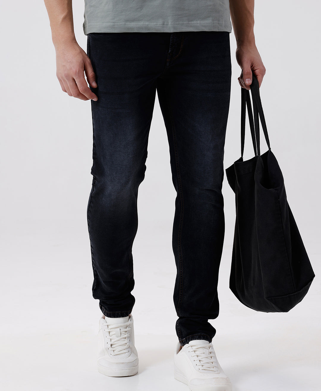 Woman wearing a red natural fade wash red cast denim on a light gray background