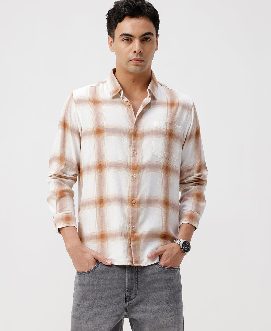 Man wearing a red textured grunge print shirt with casual styling on a gray background