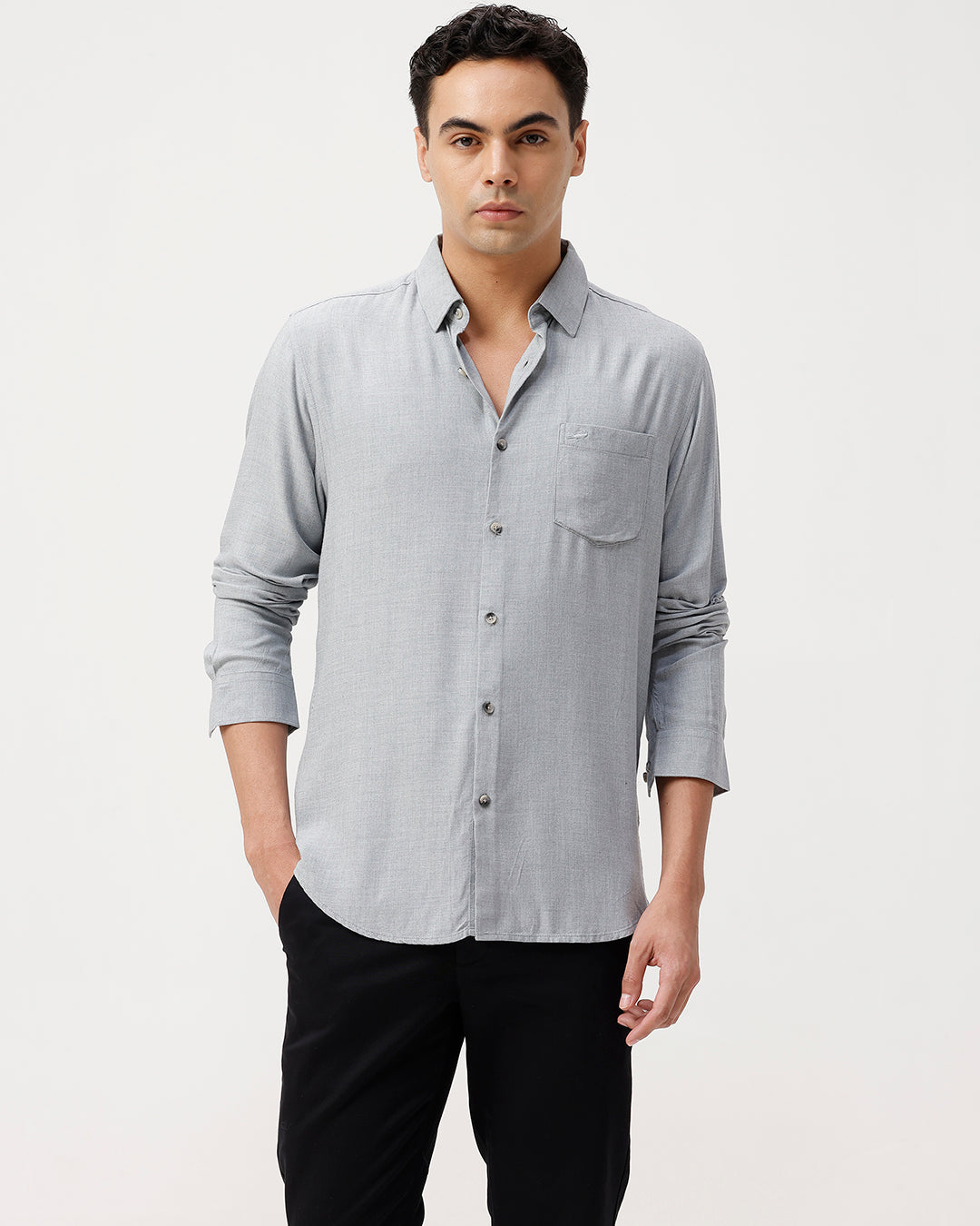 Man wearing a premium tensil linen shirt on a light gray background