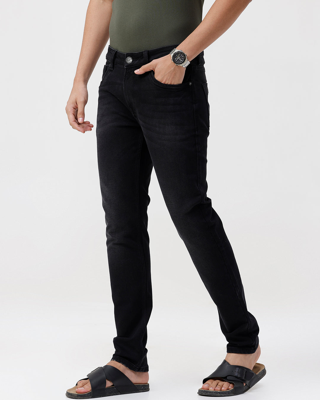Person wearing black jeans on a white background