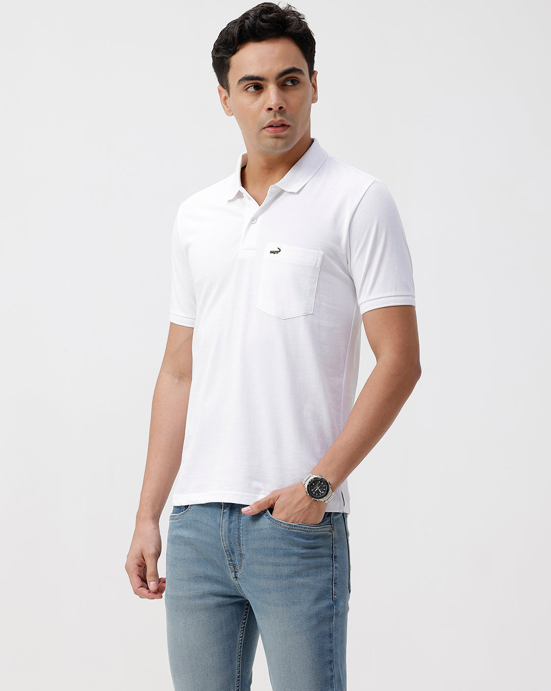 Man wearing a white solid white slim fit polo t shirt with casual styling on a gray background