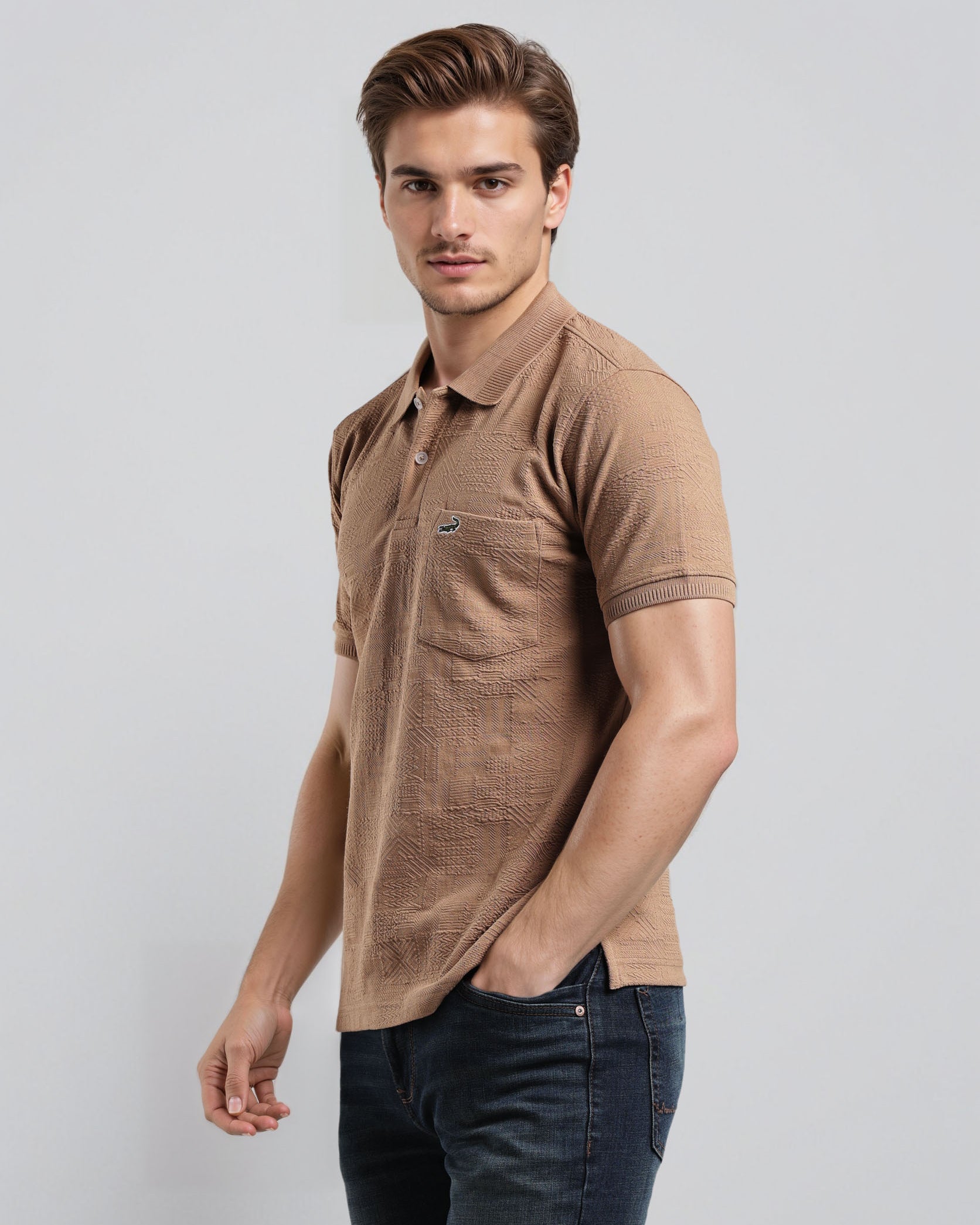 Man wearing a brown polo shirt and dark jeans on a light gray background