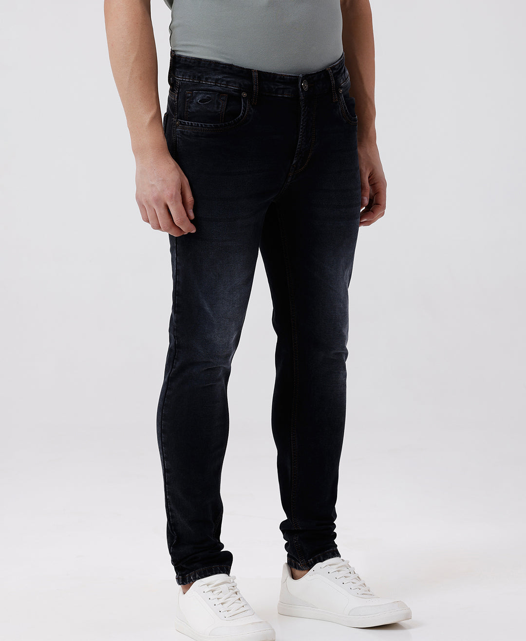 Woman wearing a red natural fade wash red cast denim on a light gray background