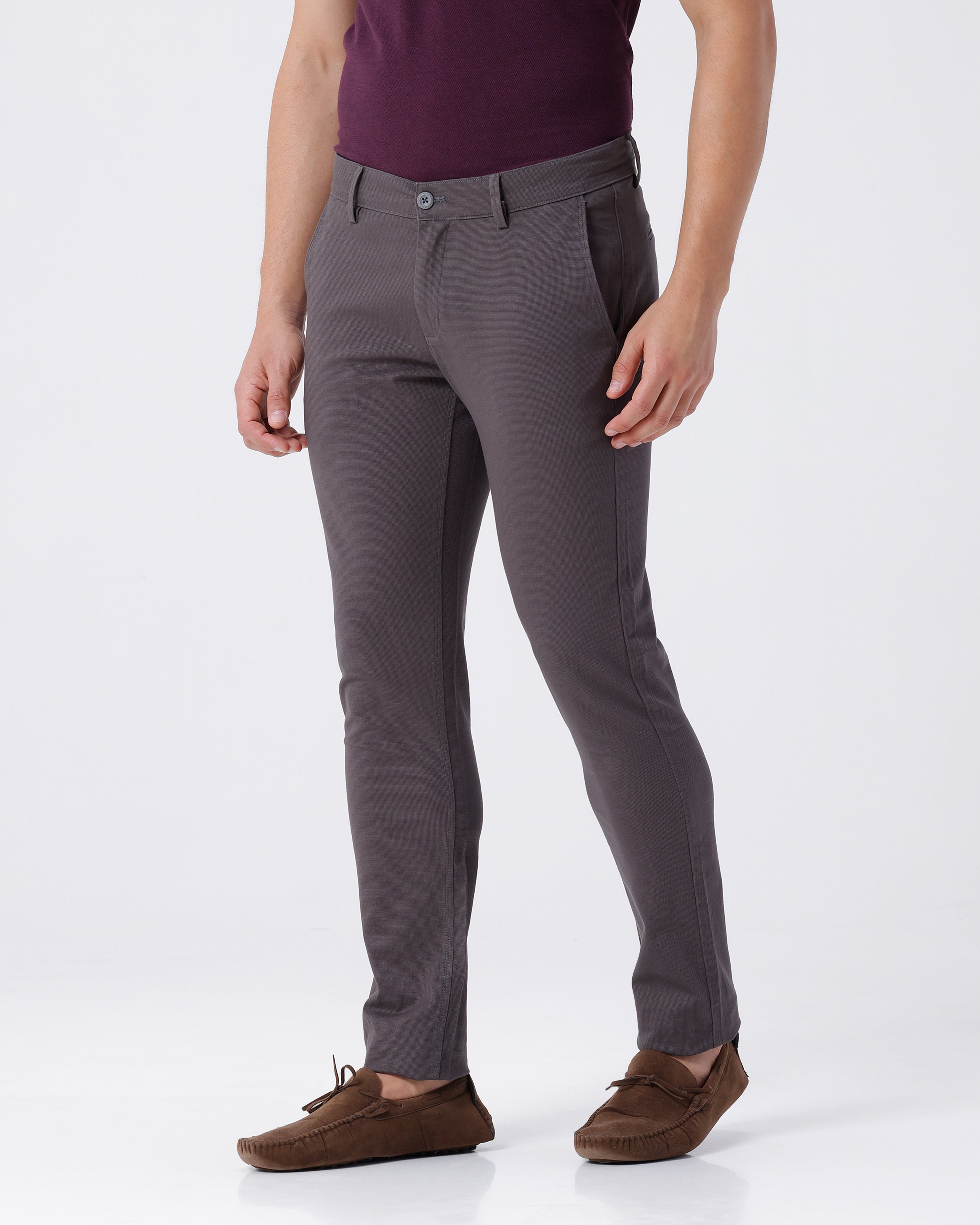Woman wearing a grey textured essential chinos in dark grey with casual styling on a gray background