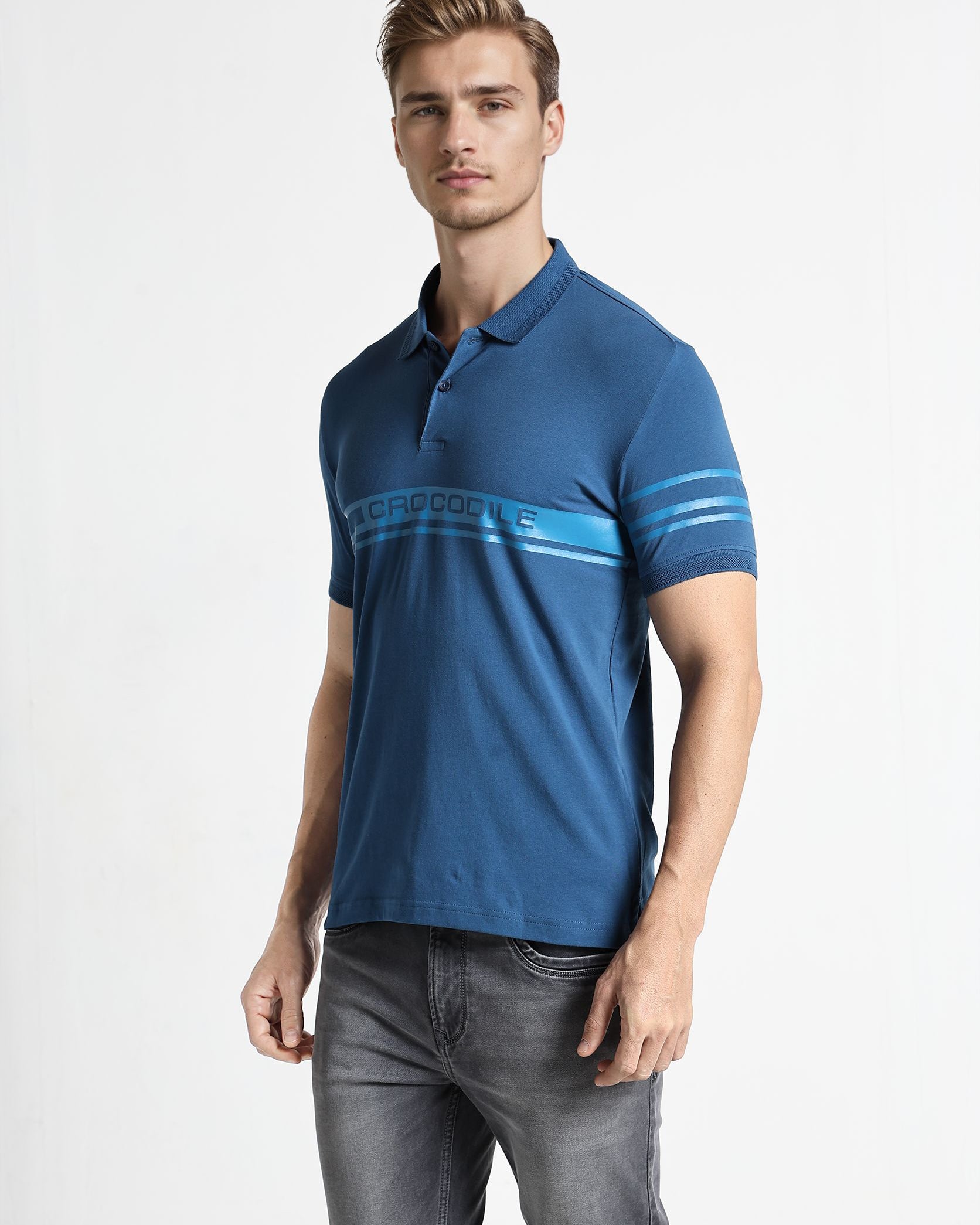 Man wearing a blue polo shirt with a white background