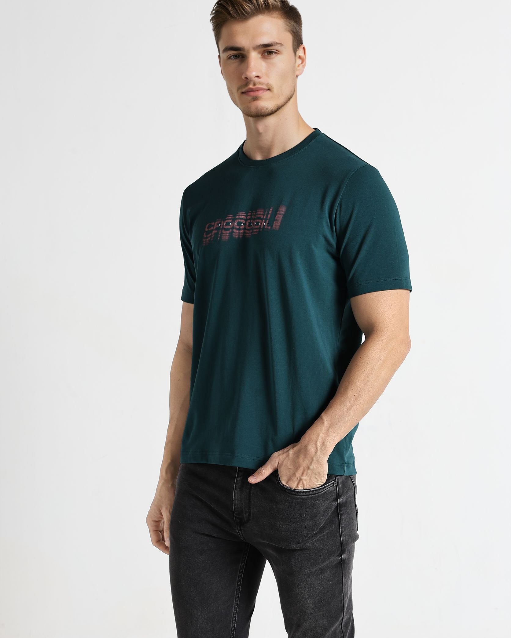 Man wearing a dark green t-shirt with text on a white background