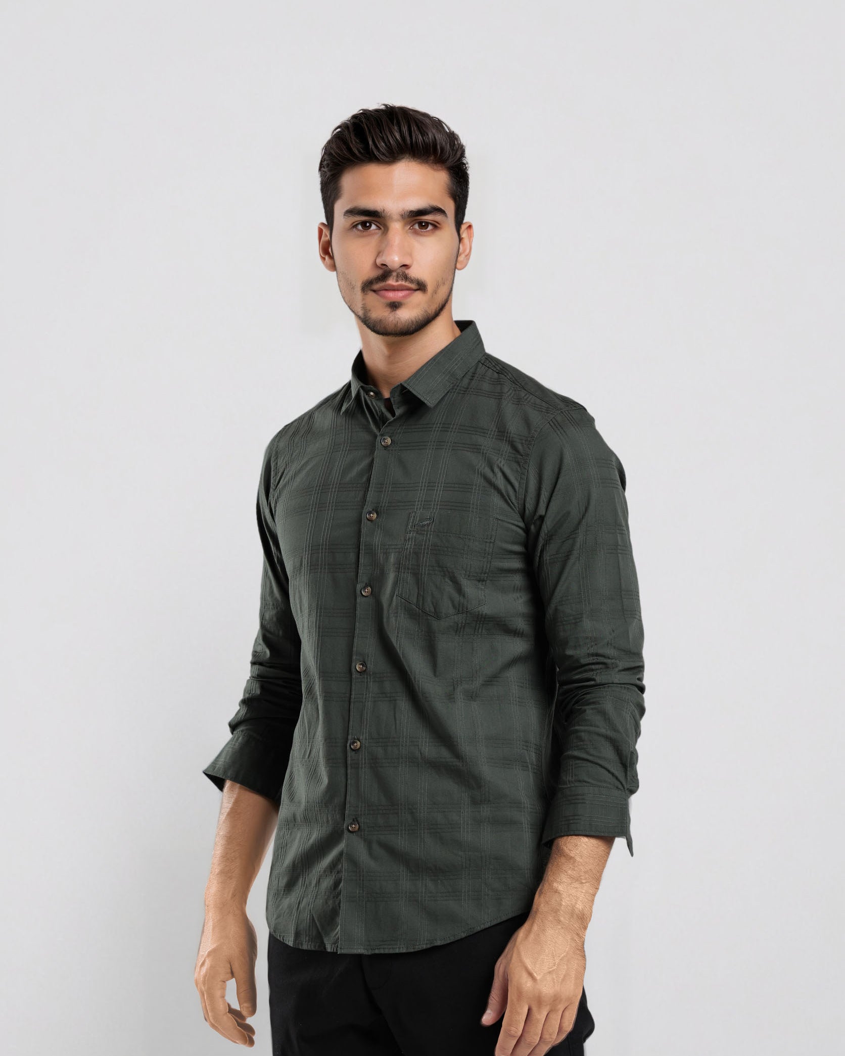 Man wearing a dark green button-up shirt against a white background