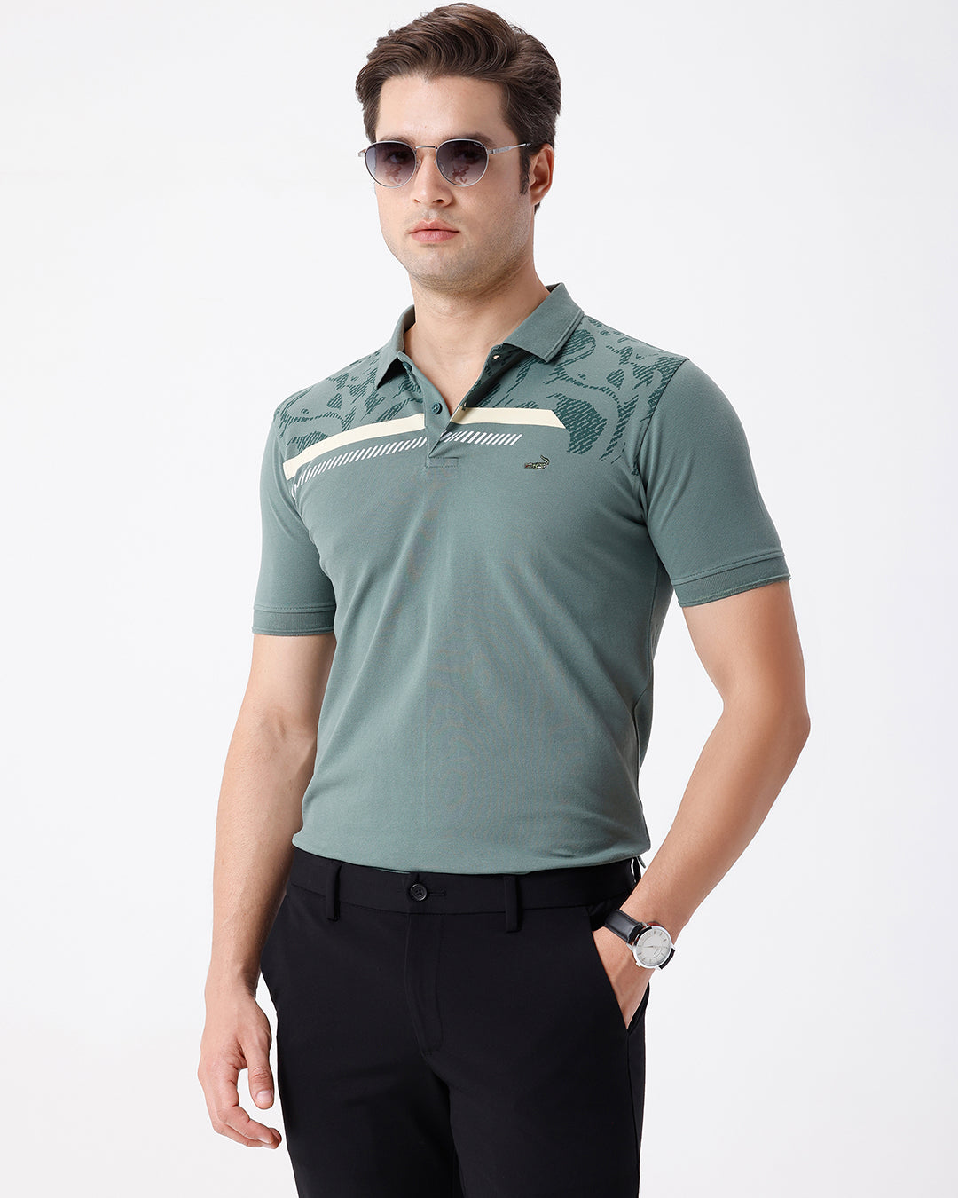 Man wearing a green iceberg green chest print slim fit polo t shirt on a light gray background