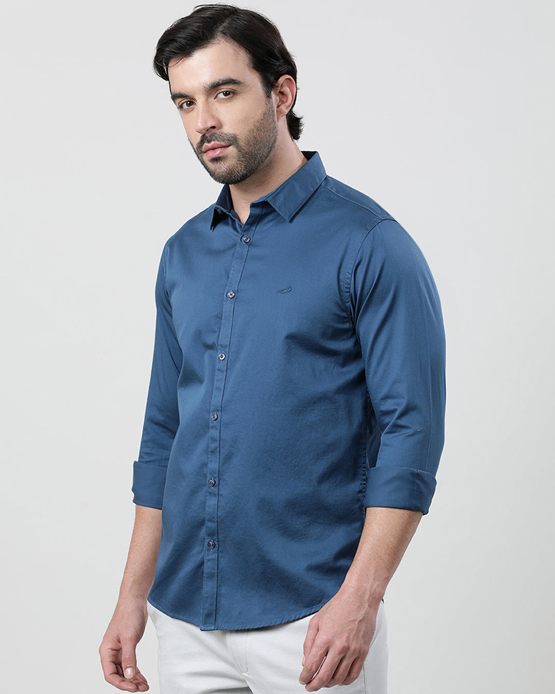 Man wearing a blue royal blue solid full sleeve 100% cotton shirt with casual styling on a gray background