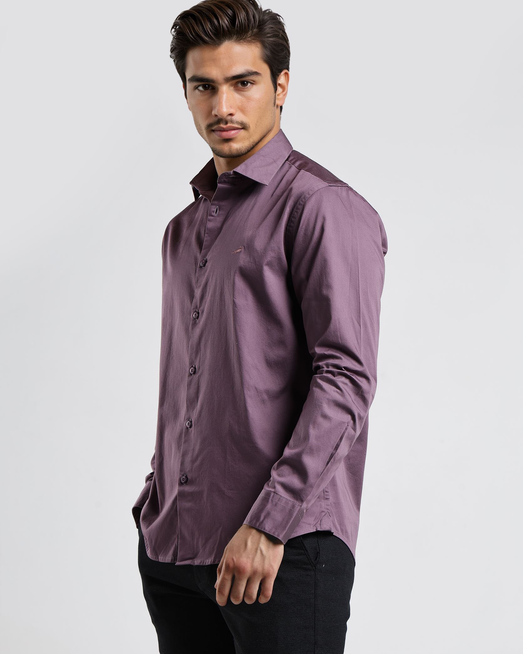 Man wearing a purple shirt against a white background