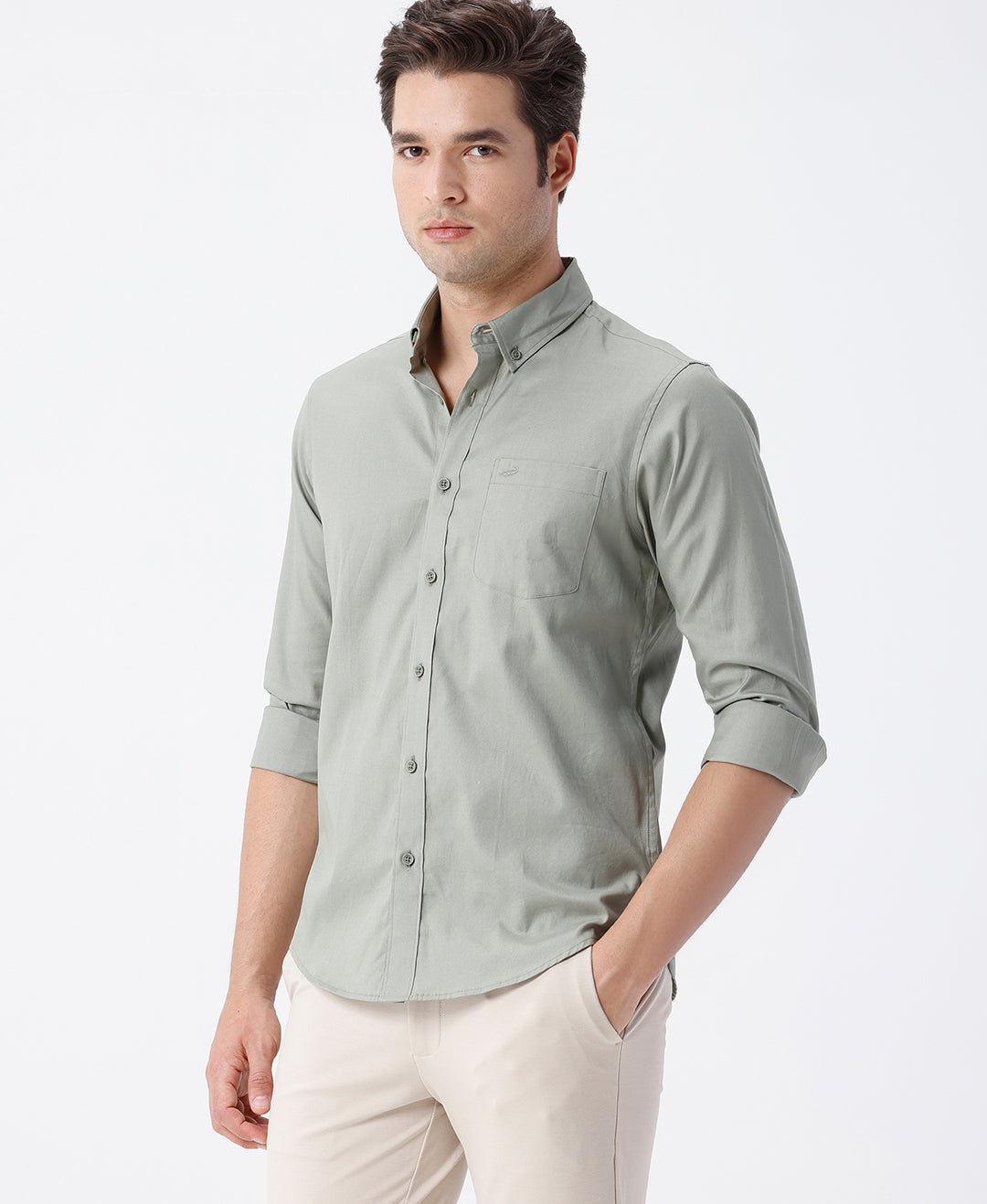 Man wearing a green smart series premium oxford shirt green with casual styling on a gray background