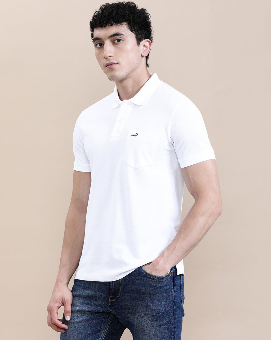Man wearing a white white solid polo t shirt with pocket with casual styling on a gray background