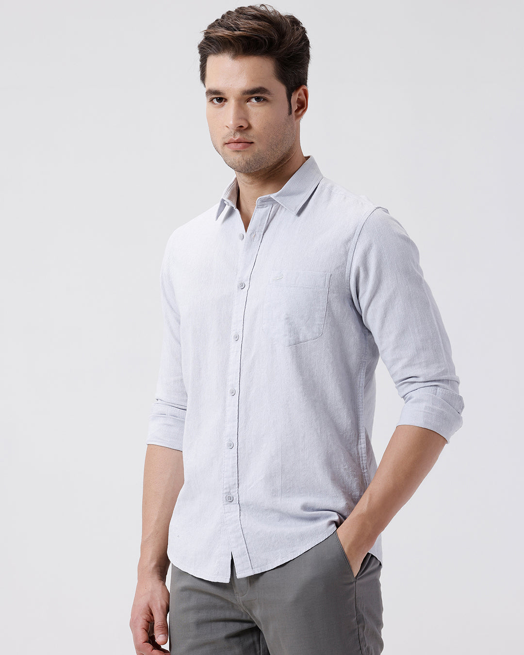 Man wearing a grey rib textured cotton shirt grey on a light gray background
