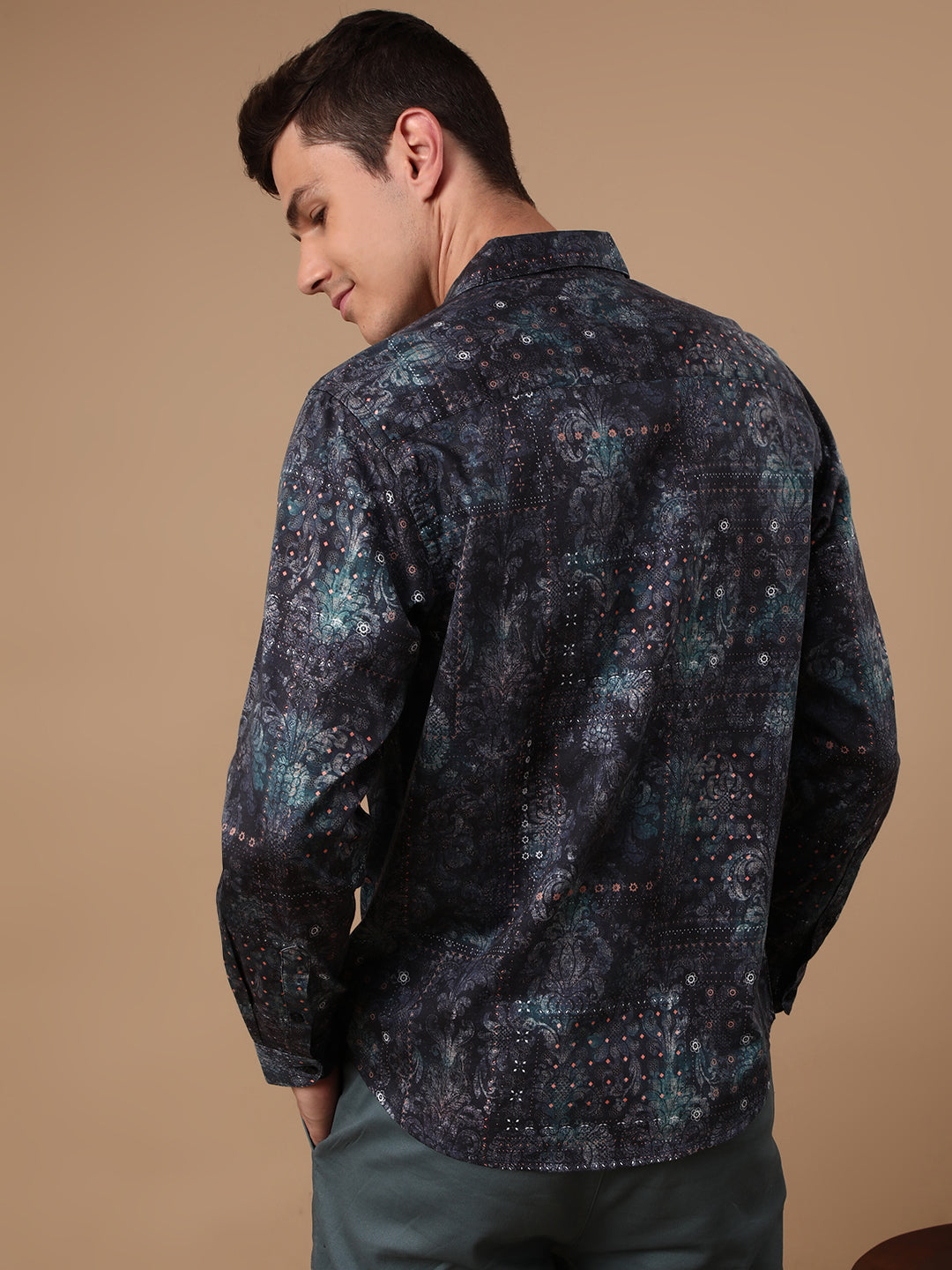 Man wearing a navy printed full sleeve 100% cotton navy casual shirt on a light gray background