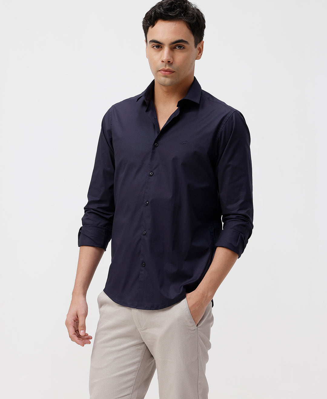 Man wearing a navy mercerized stretch shirt navy with casual styling on a gray background