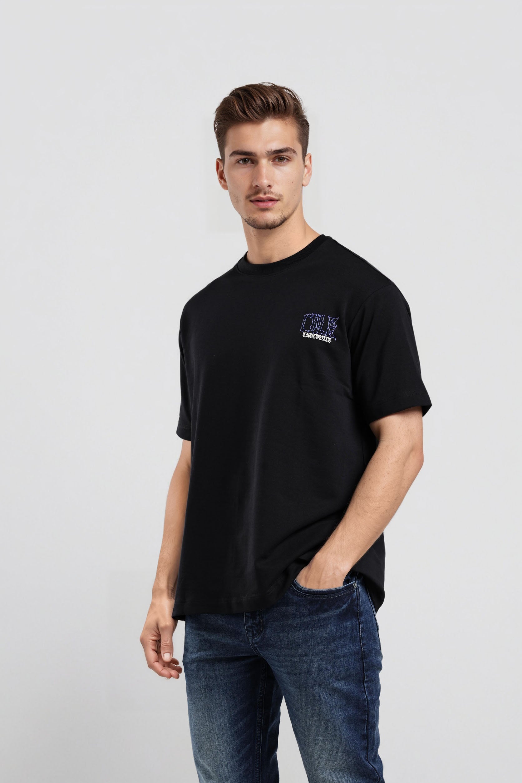 Man wearing a black t-shirt with a logo on a light gray background