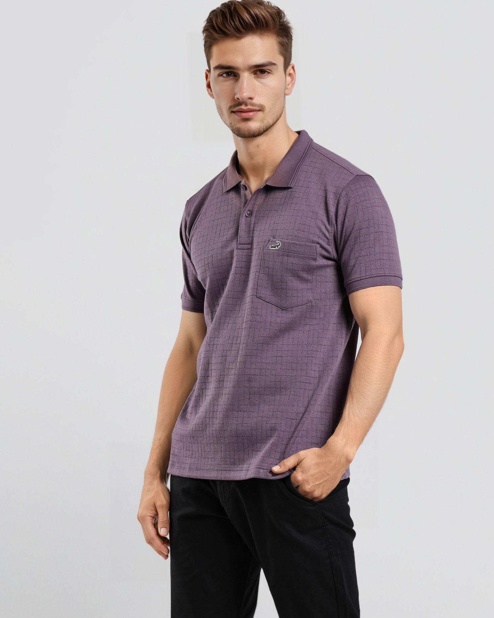 Man wearing a purple polo shirt and black pants on a light gray background