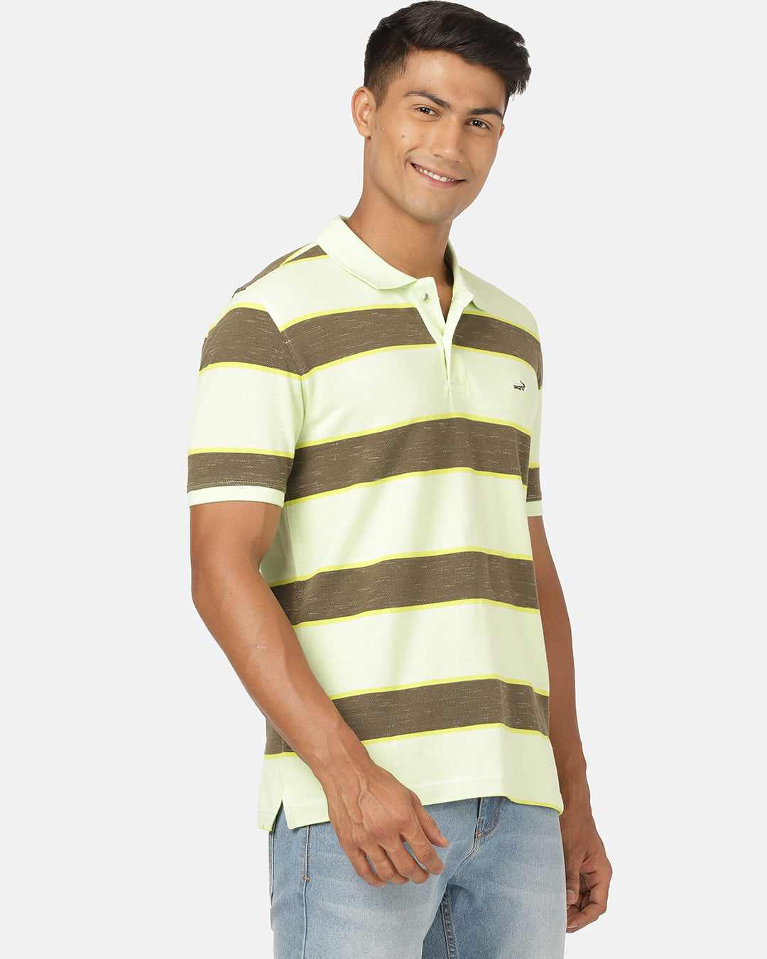 Man wearing a green butterfly green striped polo t shirt with casual styling on a gray background