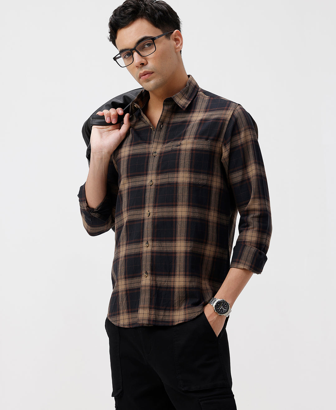 Man wearing a brown oxford checks shirt brown with casual styling on a gray background