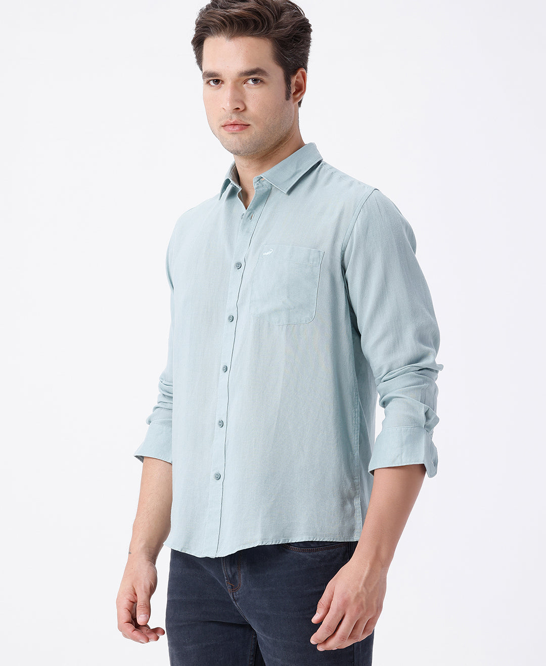 Man wearing a green linen blend shirt in green on a light gray background