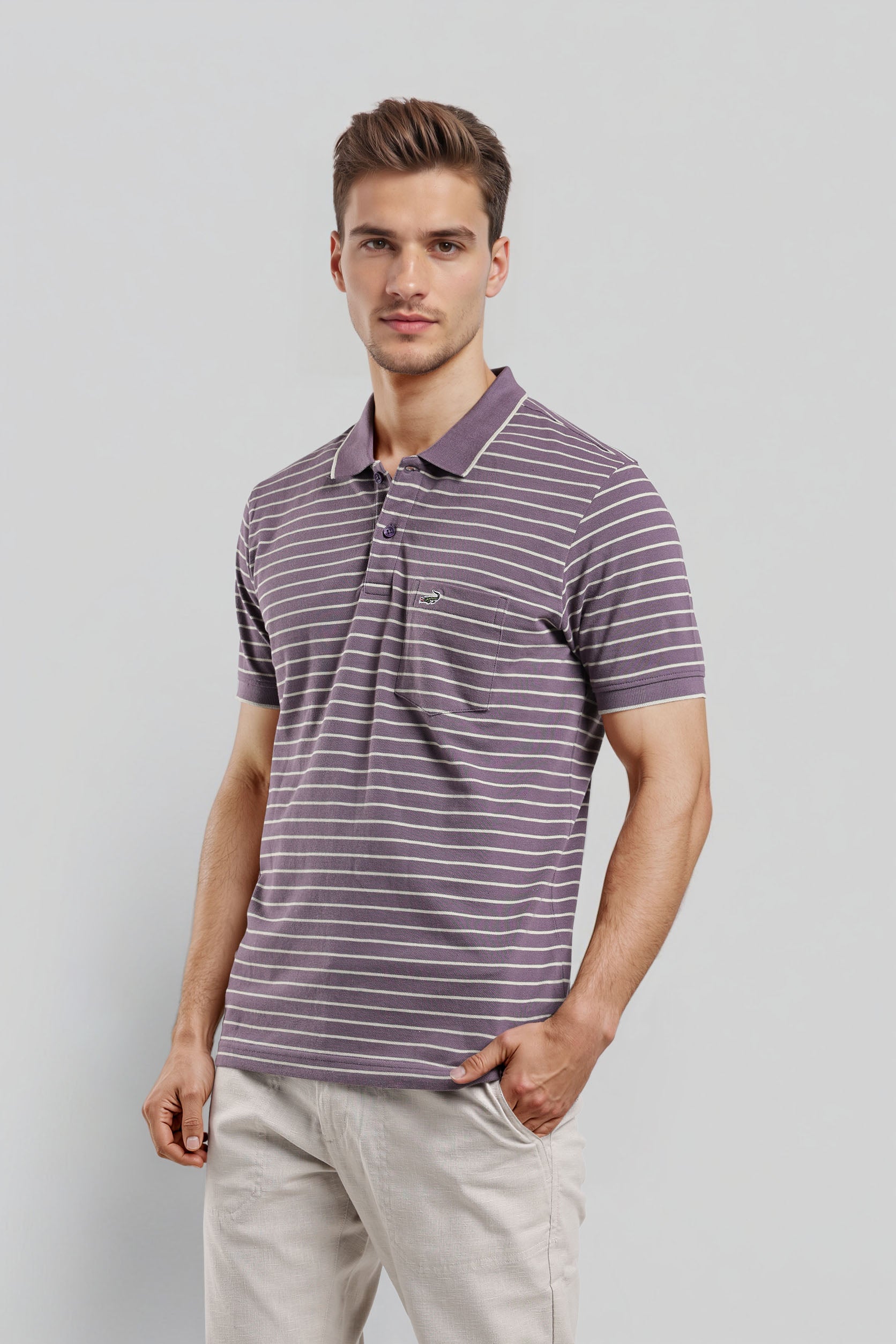 Man wearing a purple striped polo shirt against a gray background