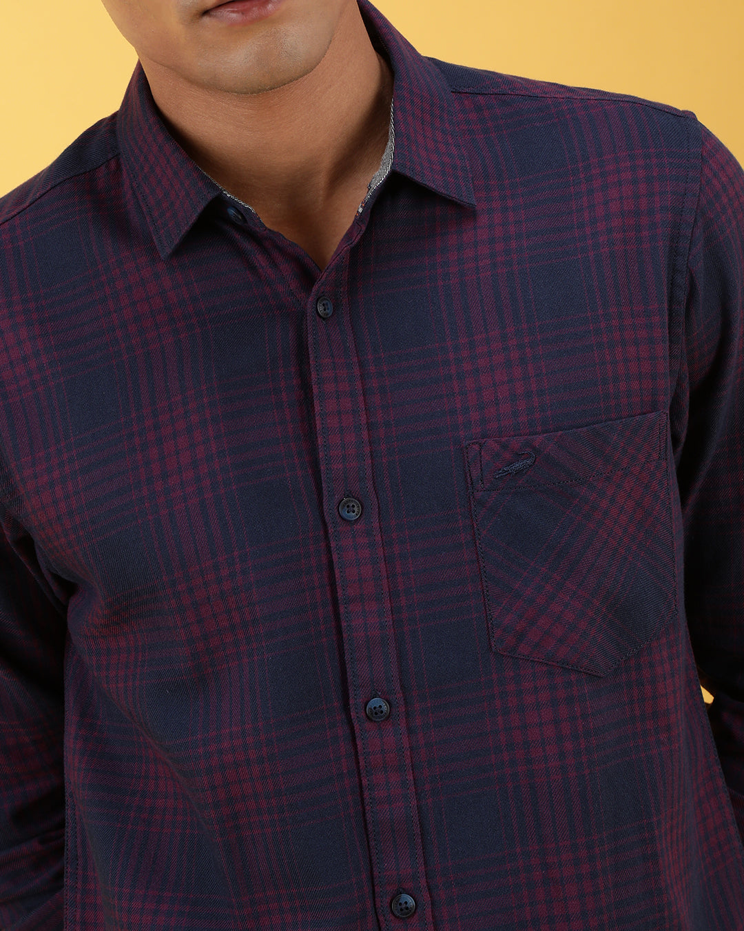 Man wearing a pink dark pink checked full sleeve 100% cotton shirt on a light gray background