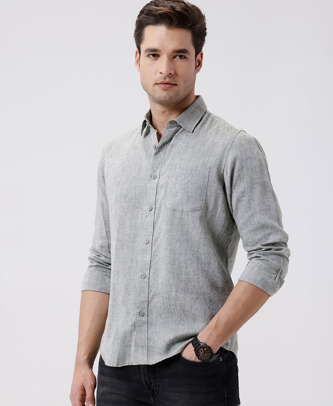 Man wearing a green premium tensil linen shirt dark green on a light gray background