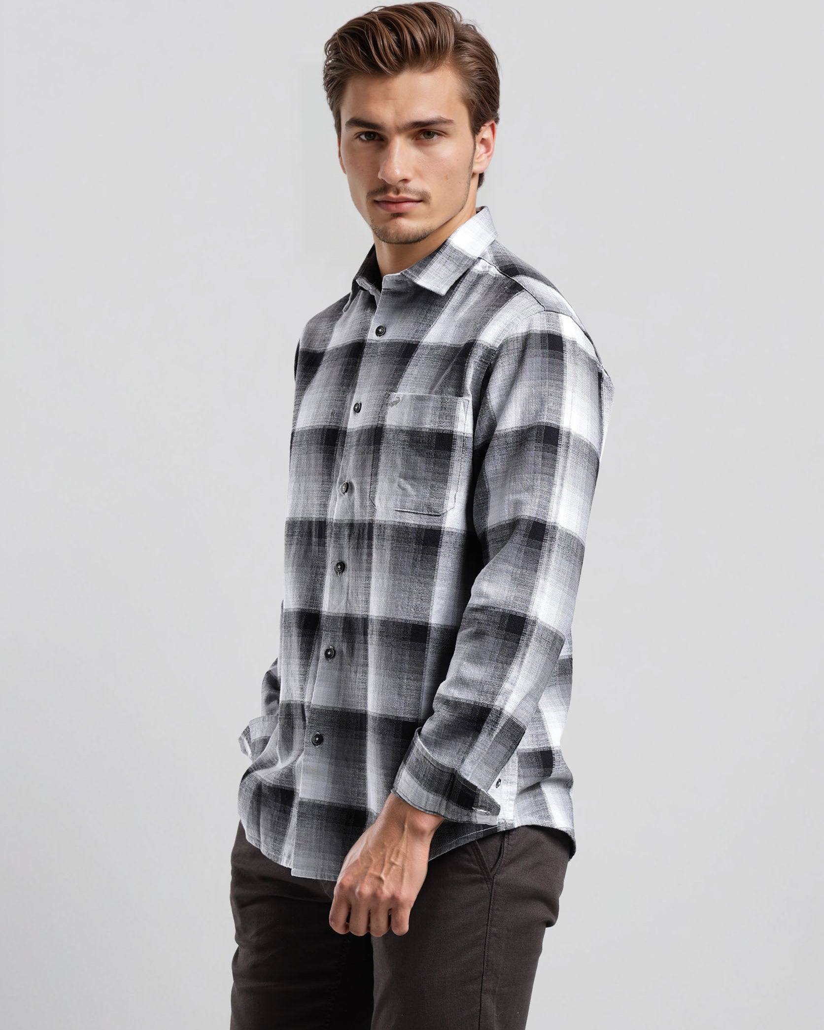 Man wearing a plaid shirt on a gray background