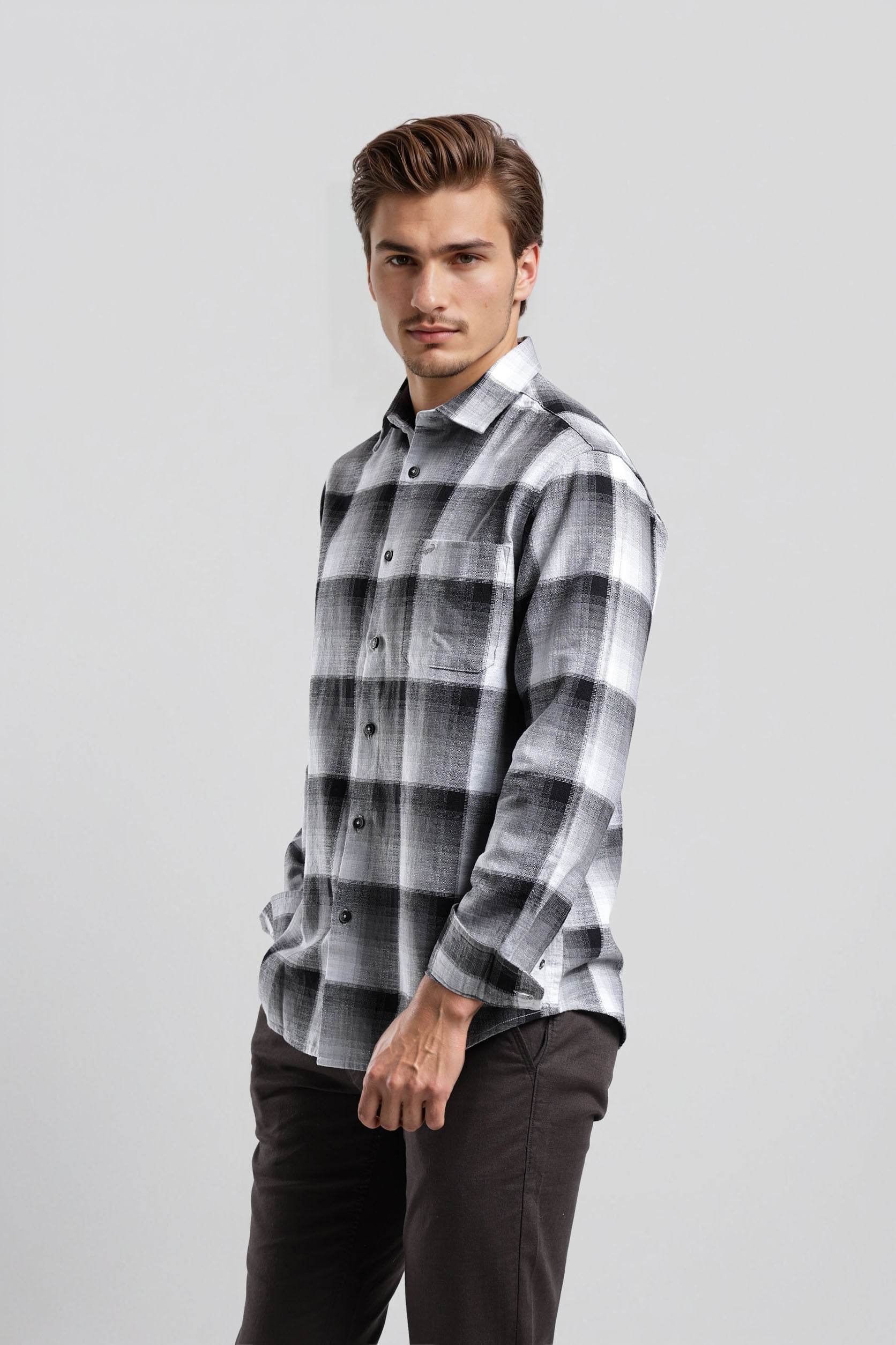 Man wearing a plaid shirt on a gray background