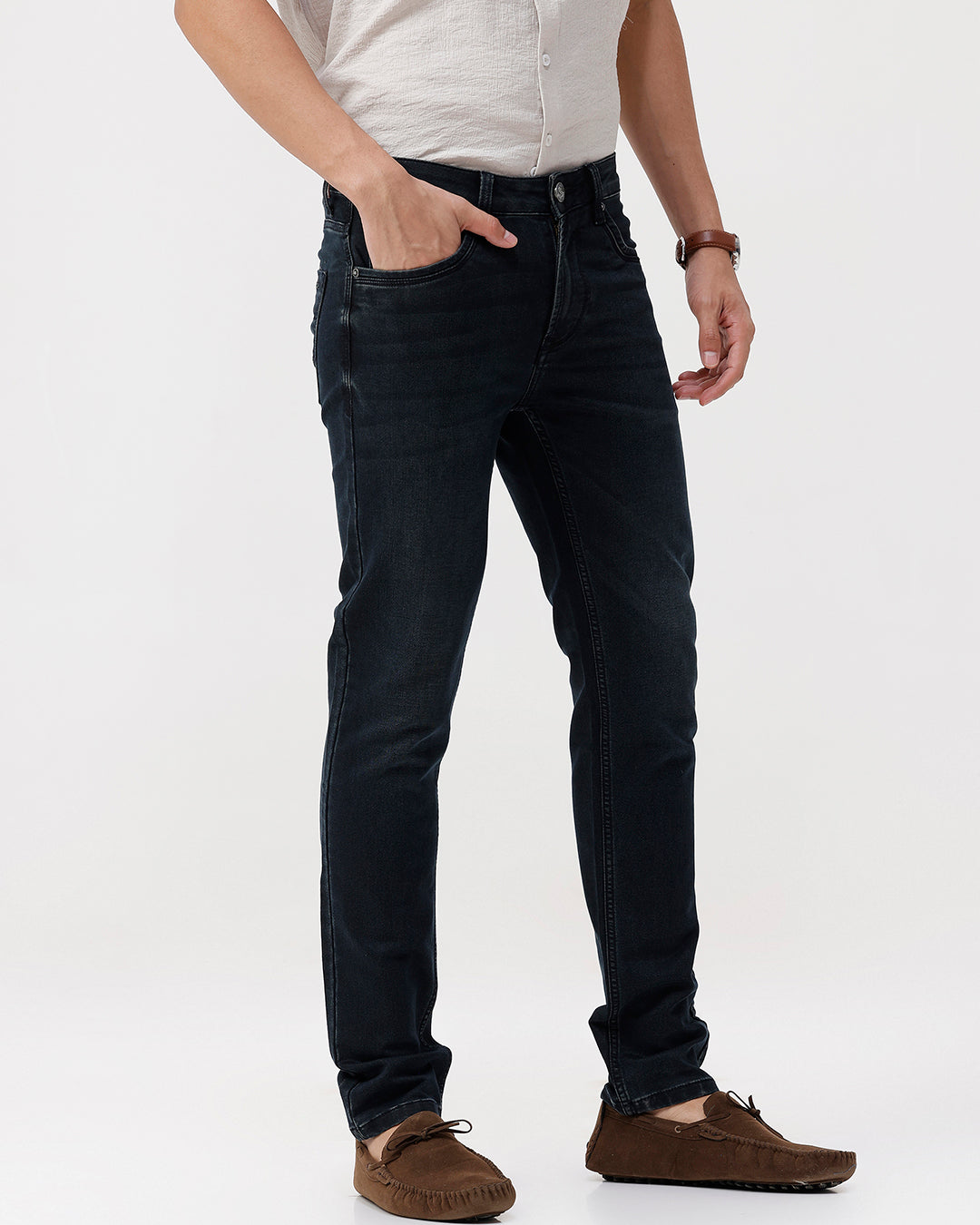 Person wearing black jeans and a white shirt on a white background