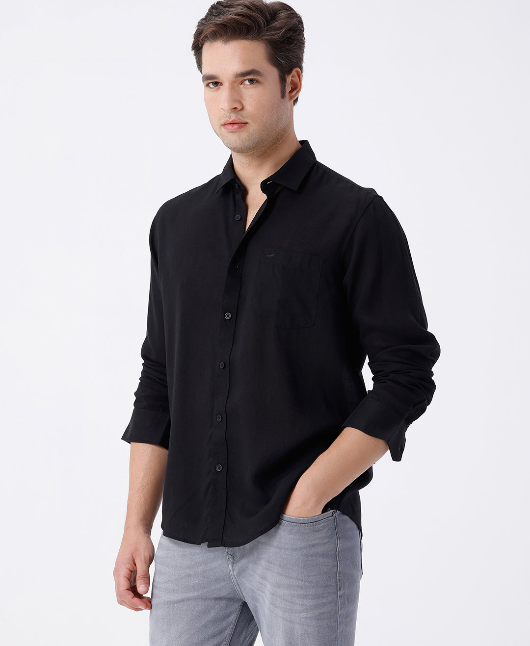 Man wearing a black linen blend shirt in black with casual styling on a gray background