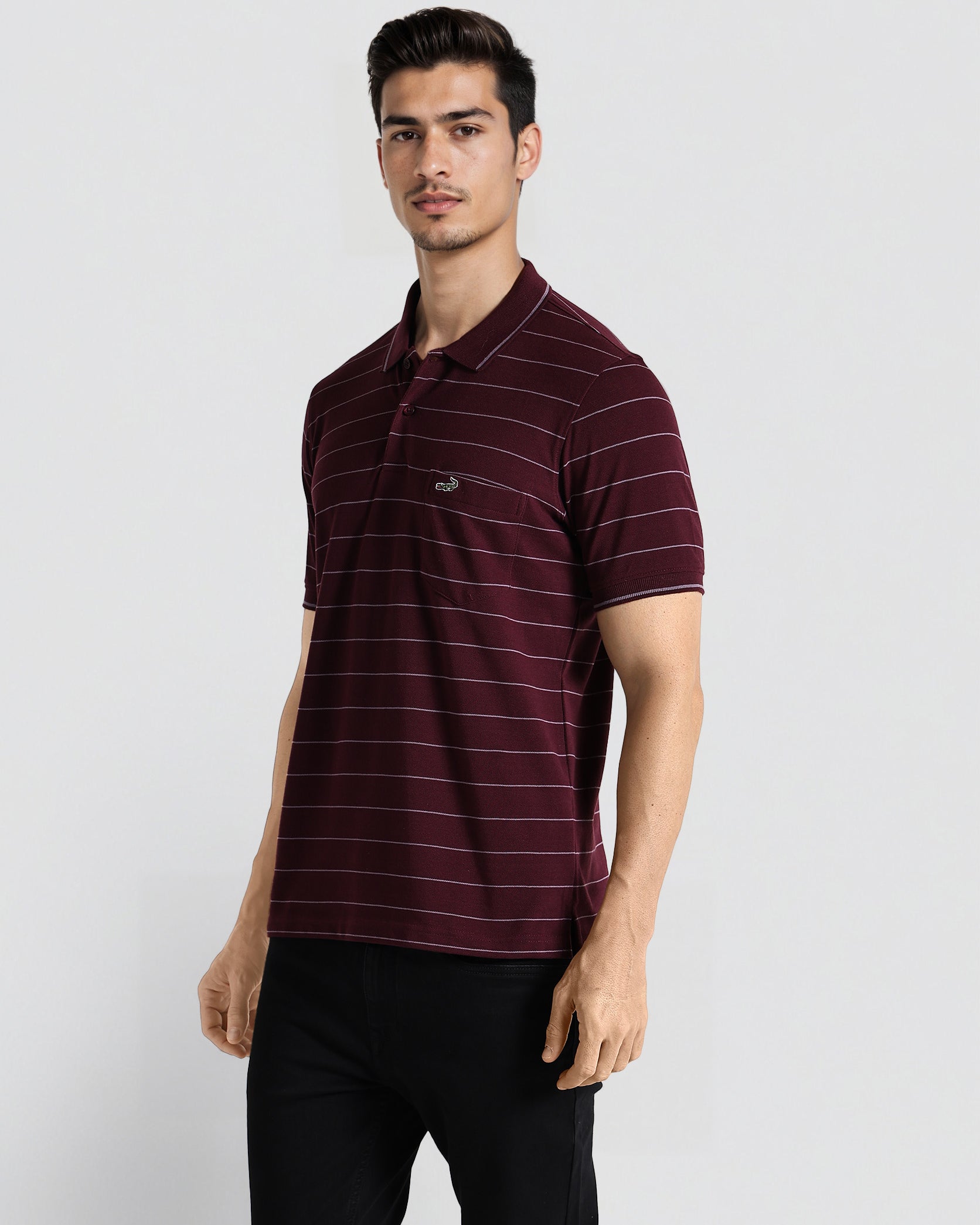 Man wearing a maroon striped polo shirt on a white background