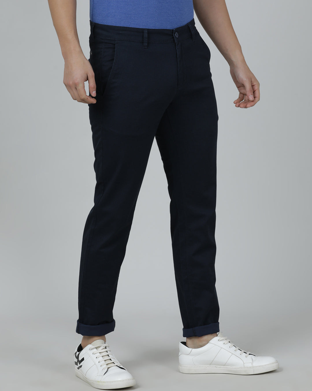 Man wearing a navy navy casual printed trouser with casual styling on a gray background